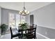 Bright dining room with natural light, square table, and backyard views at 7899 S Timber Cliff Ln, Trafalgar, IN 46181