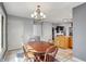 Dining area with wood table and chandelier located near the kitchen area and convenient pantry storage at 7899 S Timber Cliff Ln, Trafalgar, IN 46181