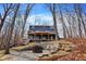 Lake house featuring wooden decks, beautiful wooded views, and an outdoor fire pit with seating at 7899 S Timber Cliff Ln, Trafalgar, IN 46181