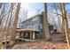 Rear view of the lake house featuring wood siding, large deck, and surrounded by beautiful trees at 7899 S Timber Cliff Ln, Trafalgar, IN 46181