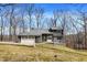 Charming two-story home with stone accents, a two-car garage, and a deck overlooking a tree-filled yard at 7899 S Timber Cliff Ln, Trafalgar, IN 46181
