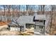 Charming two-story home with stone accents, a two-car garage, and a deck overlooking a tree-filled yard at 7899 S Timber Cliff Ln, Trafalgar, IN 46181