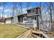 Charming two-story home with stone accents, a two-car garage, and a deck overlooking a tree-filled yard at 7899 S Timber Cliff Ln, Trafalgar, IN 46181