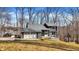 Charming two-story home with stone accents, a two-car garage, and a deck overlooking a tree-filled yard at 7899 S Timber Cliff Ln, Trafalgar, IN 46181