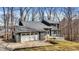 Charming two-story home with stone accents, a two-car garage, and a deck overlooking a tree-filled yard at 7899 S Timber Cliff Ln, Trafalgar, IN 46181
