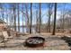 Outdoor fire pit with seating area, surrounded by trees and beautiful lake views at 7899 S Timber Cliff Ln, Trafalgar, IN 46181