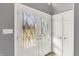 Bright foyer featuring decorative double-door entry and coat closet with white doors and trim at 7899 S Timber Cliff Ln, Trafalgar, IN 46181