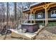 Exterior view of a hot tub and deck space with stairs leading to the main house at 7899 S Timber Cliff Ln, Trafalgar, IN 46181