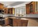 Well-lit kitchen with wood cabinets, stainless steel appliances, and a bay window over the sink at 7899 S Timber Cliff Ln, Trafalgar, IN 46181