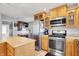 Well-equipped kitchen with stainless steel appliances, tile flooring, and wood cabinetry at 7899 S Timber Cliff Ln, Trafalgar, IN 46181