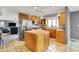 Open-concept kitchen with island, stainless steel appliances, and lots of natural light at 7899 S Timber Cliff Ln, Trafalgar, IN 46181