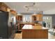 Spacious kitchen featuring stainless steel appliances, an island, and wood cabinets at 7899 S Timber Cliff Ln, Trafalgar, IN 46181