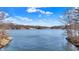 Expansive lake view showcases serene waters and distant homes under a bright, partly cloudy sky at 7899 S Timber Cliff Ln, Trafalgar, IN 46181