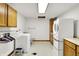 Functional laundry room with washer, dryer, cabinetry, and utility sink at 7899 S Timber Cliff Ln, Trafalgar, IN 46181