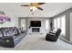 Inviting living room with a brick fireplace, a ceiling fan, neutral decor, and comfortable leather seating at 7899 S Timber Cliff Ln, Trafalgar, IN 46181
