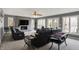 Spacious living room with brick fireplace, plush seating, and large windows offering views of the lake at 7899 S Timber Cliff Ln, Trafalgar, IN 46181
