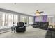 Spacious living room with plush seating and large windows offering views of the outdoors and a serene atmosphere at 7899 S Timber Cliff Ln, Trafalgar, IN 46181