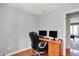 Bright office with wood desk, two monitors, and view of the main living area at 7899 S Timber Cliff Ln, Trafalgar, IN 46181
