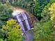 Picturesque tiered waterfall cascading through lush green foliage, seen from above at 7899 S Timber Cliff Ln, Trafalgar, IN 46181