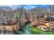 Scenic waterfront view with lush trees, a dock, and inviting outdoor seating area at 7899 S Timber Cliff Ln, Trafalgar, IN 46181