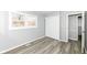 Bedroom features a window and closet doors and light gray walls and wood-look flooring at 8026 Roy Rd, Indianapolis, IN 46219