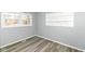 Cozy bedroom showcasing gray walls, wood-look flooring, and a window at 8026 Roy Rd, Indianapolis, IN 46219