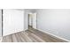 Bright bedroom features modern gray walls, wood-look floors, and a closet with white paneled doors at 8026 Roy Rd, Indianapolis, IN 46219