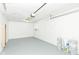 The garage features gray floor and walls, a boiler on the wall, and stored paint cans at 8026 Roy Rd, Indianapolis, IN 46219