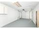 Garage featuring gray sealed floor and white walls and ceiling, along with a garage door at 8026 Roy Rd, Indianapolis, IN 46219