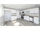 Modern kitchen with stainless steel appliances, vinyl flooring, and sleek countertops at 8026 Roy Rd, Indianapolis, IN 46219