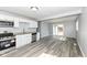 This home features a modern kitchen with stainless steel appliances, vinyl flooring, and sleek countertops at 8026 Roy Rd, Indianapolis, IN 46219