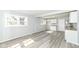 Well-lit kitchen featuring modern wood-look floors, white cabinets, and a window at 8026 Roy Rd, Indianapolis, IN 46219
