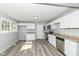 This home features a modern kitchen with stainless steel appliances, vinyl flooring, and sleek countertops at 8026 Roy Rd, Indianapolis, IN 46219