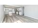 Charming kitchen with white cabinets, stainless steel appliances, and modern wood-look floors at 8026 Roy Rd, Indianapolis, IN 46219