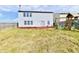 Backyard featuring a light blue house, red deck, and play set and swing at 8630 Aylesworth Dr, Camby, IN 46113