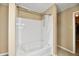Bright bathroom features a white tiled tub and shower combination with silver fixtures at 8630 Aylesworth Dr, Camby, IN 46113