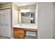 Bathroom featuring a vanity with a sink, white countertop, and a large mirror and cabinets at 8630 Aylesworth Dr, Camby, IN 46113