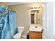 Neutral-toned bathroom with a shower featuring a blue-patterned curtain at 8630 Aylesworth Dr, Camby, IN 46113