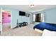 Bright bedroom featuring light blue walls, a flat-screen TV, and neutral carpeting at 8630 Aylesworth Dr, Camby, IN 46113