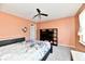 Cozy bedroom features a queen-sized bed, decorative ceiling fan, and neutral carpeting at 8630 Aylesworth Dr, Camby, IN 46113