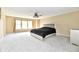 Spacious bedroom with neutral walls, carpet, ceiling fan, and bright windows at 8630 Aylesworth Dr, Camby, IN 46113