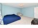 Cozy bedroom with blue walls, neutral carpet, and a comfortable-looking armchair at 8630 Aylesworth Dr, Camby, IN 46113