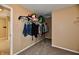 Hallway closet featuring a single hanging rack with clothing and carpet flooring at 8630 Aylesworth Dr, Camby, IN 46113