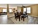 Inviting dining room features wood flooring, a ceiling fan, and a view of the living room at 8630 Aylesworth Dr, Camby, IN 46113
