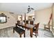 Well-lit dining room with dark wood furniture, a decorative mirror, and view into the kitchen and living room at 8630 Aylesworth Dr, Camby, IN 46113
