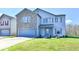 Two-story home with a brick facade, attached garage, and a lush green lawn on a sunny day at 8630 Aylesworth Dr, Camby, IN 46113