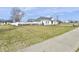Scenic view of a home and fenced yard surrounded by lush greenery, with a paved sidewalk at 8630 Aylesworth Dr, Camby, IN 46113