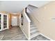 Inviting foyer featuring staircase with carpet runner, decorative mirror, and natural light at 8630 Aylesworth Dr, Camby, IN 46113