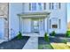 Inviting front porch with decorative landscaping, charming columns, and a stylish front door entrance at 8630 Aylesworth Dr, Camby, IN 46113