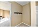 Hallway featuring beige walls, neutral floors, and a unique copper pipe coat rack at 8630 Aylesworth Dr, Camby, IN 46113